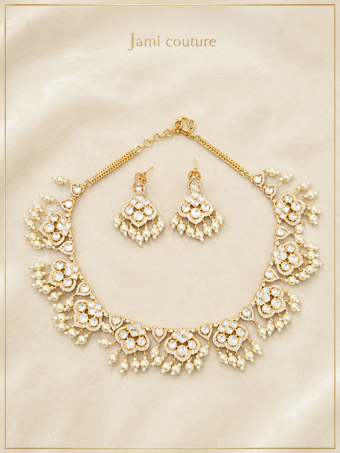 Gold kundan and pearl drop necklace with matching earrings laid flat on a cream card