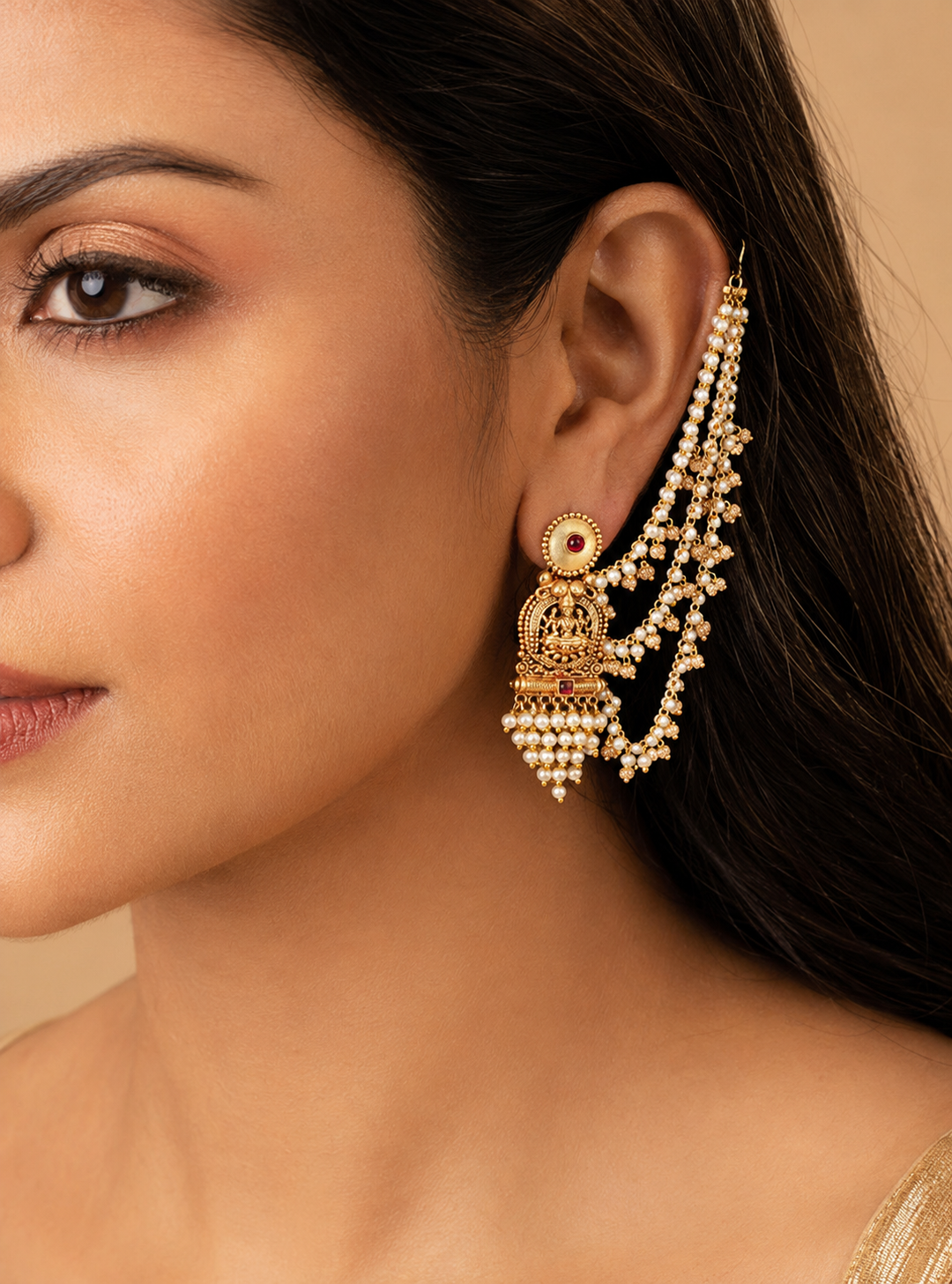 Model wearing the layered-chain Lakshmi jhumka earring with pearl strands, profile view