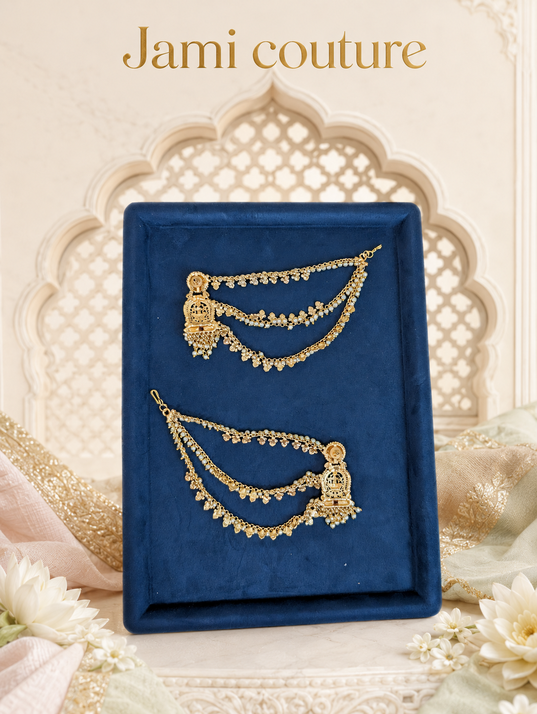 Layered pearl chain jhumka earrings on a navy tray in an arched setting