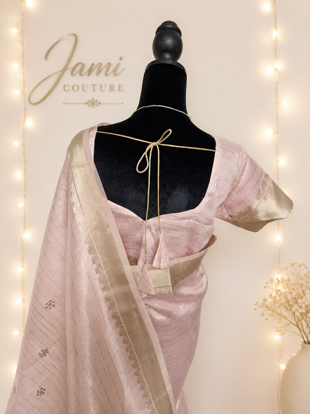 Close-up of the stitched blouse back with gold tasseled tie-back, zari-bordered sleeve and the zari-butti pallu