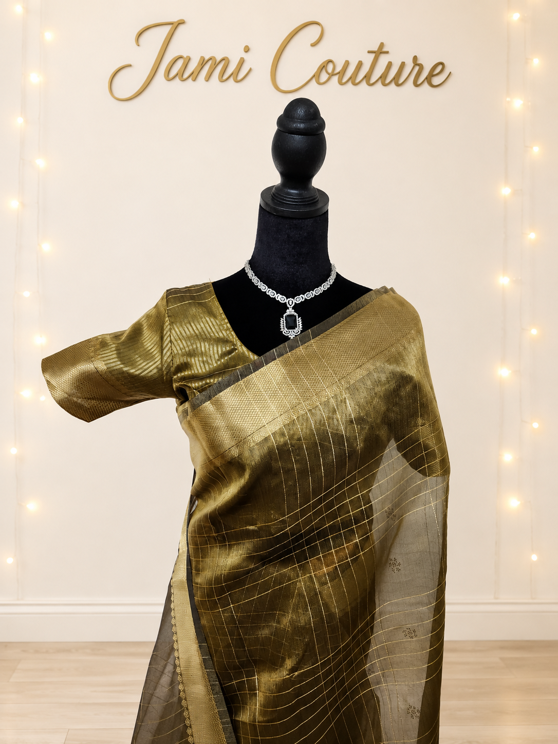 Close-up of the antique gold tissue organza drape with zari checks and matching stitched blouse