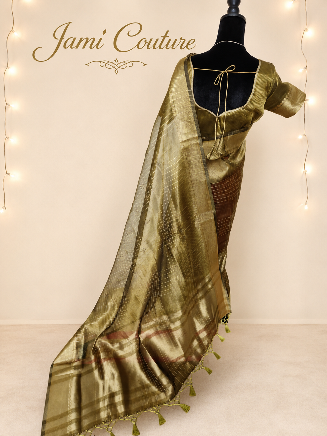 Back view of the antique gold tissue organza saree with the tasseled pallu falling to the floor