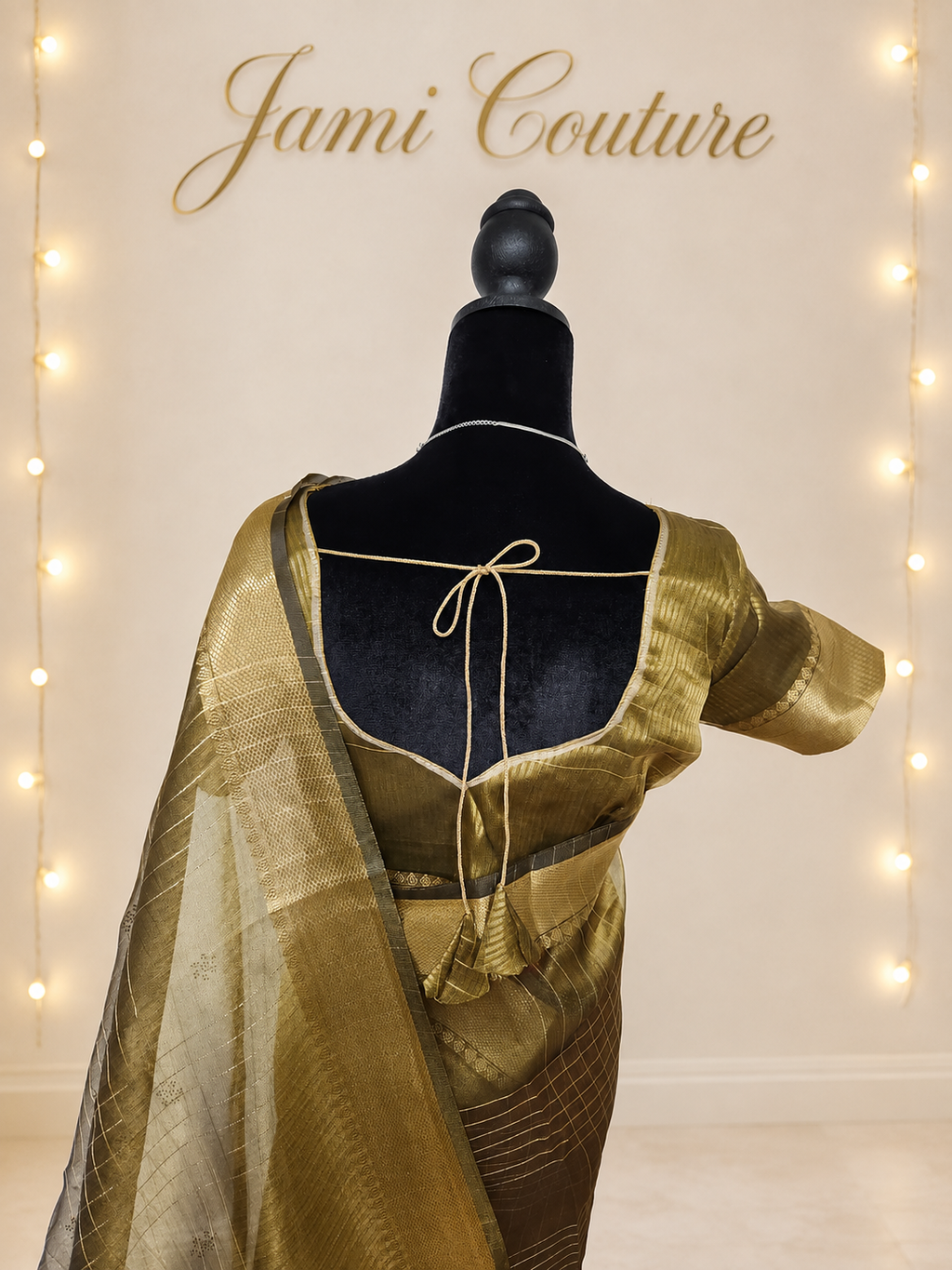 Close-up of the antique gold blouse back with tasseled tie and the zari-checked pallu