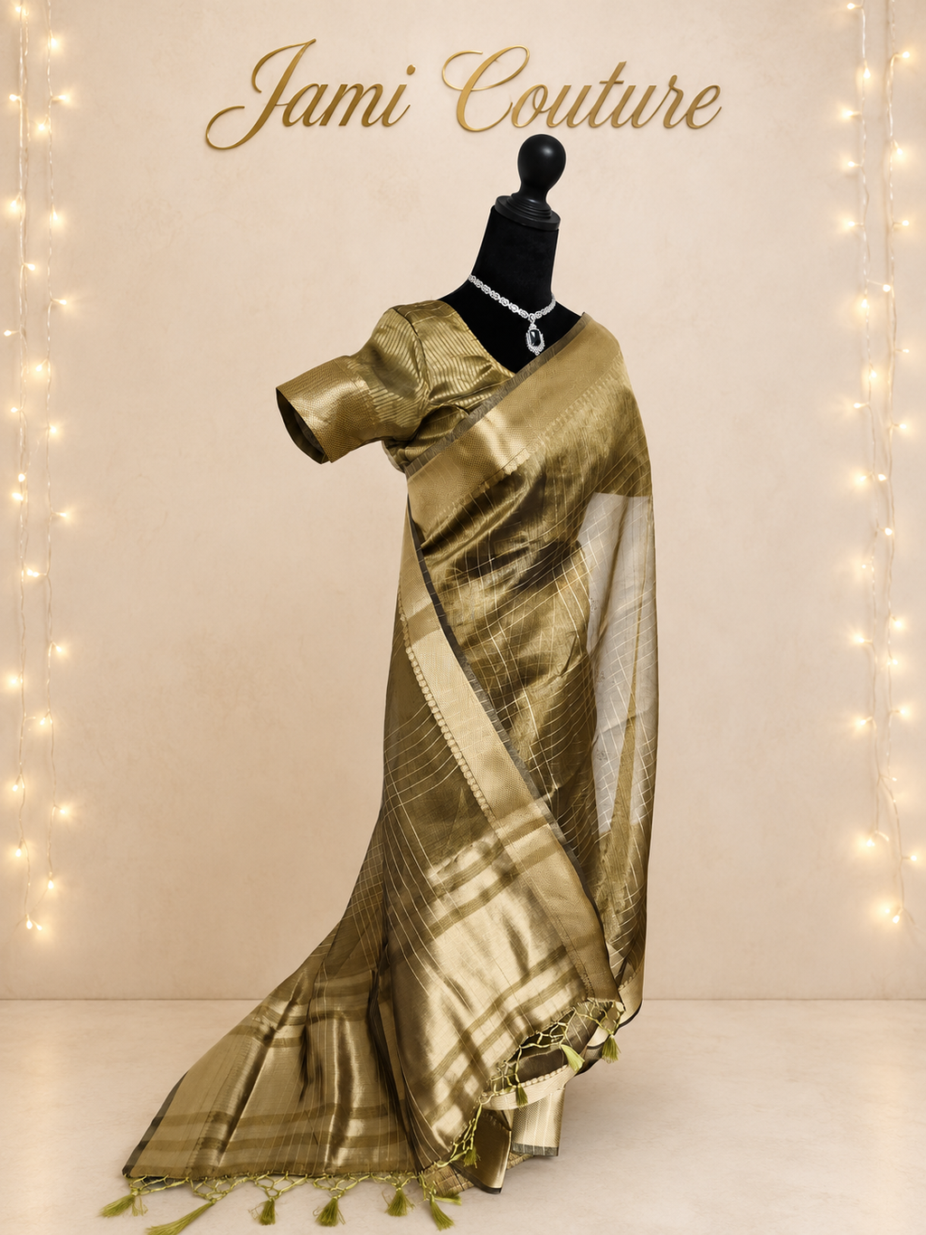 Three-quarter view of the antique gold tissue organza saree with wide zari border
