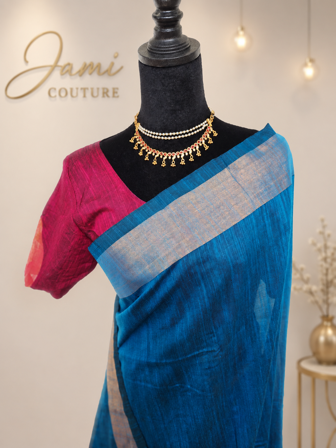 Close-up of the blue khadi cotton saree with silver border and the pink stitched blouse