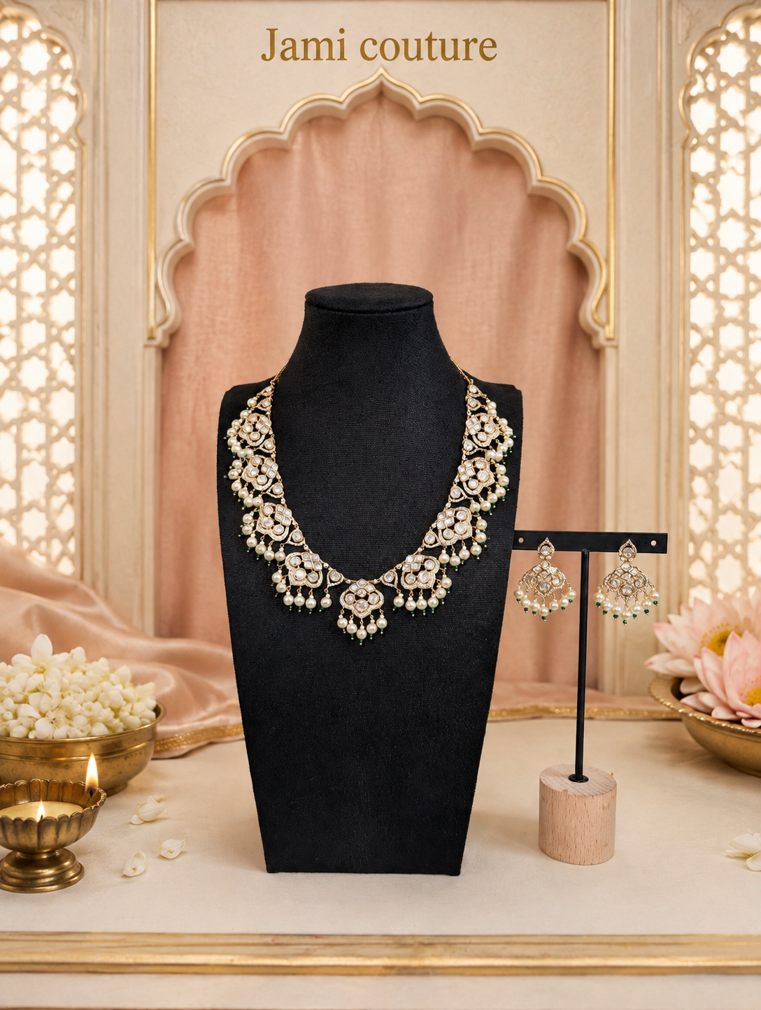 Gold kundan and pearl drop necklace on a bust with its earrings on a stand