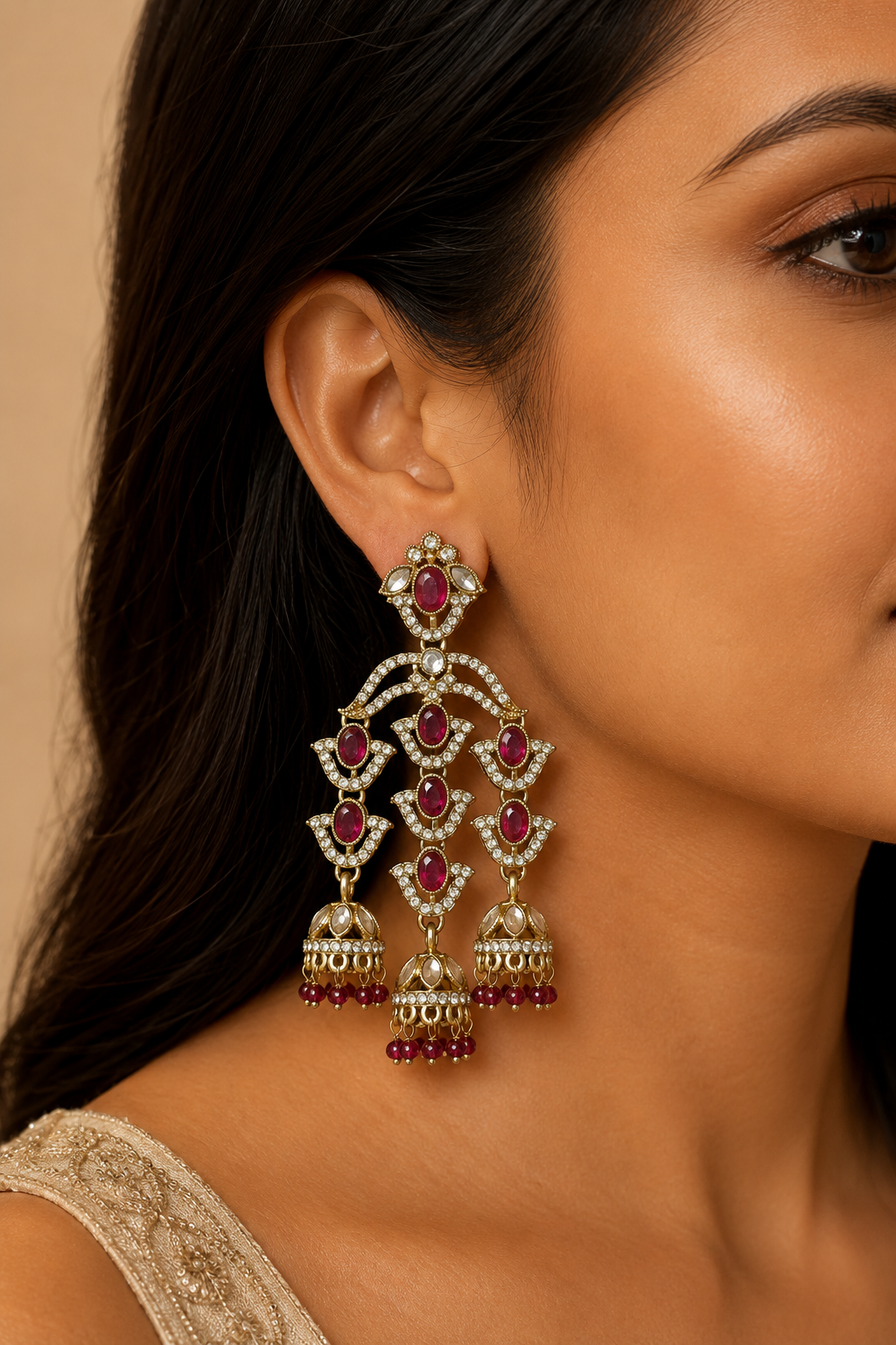 Model wearing a rani pink and white stone triple jhumka chandelier earring