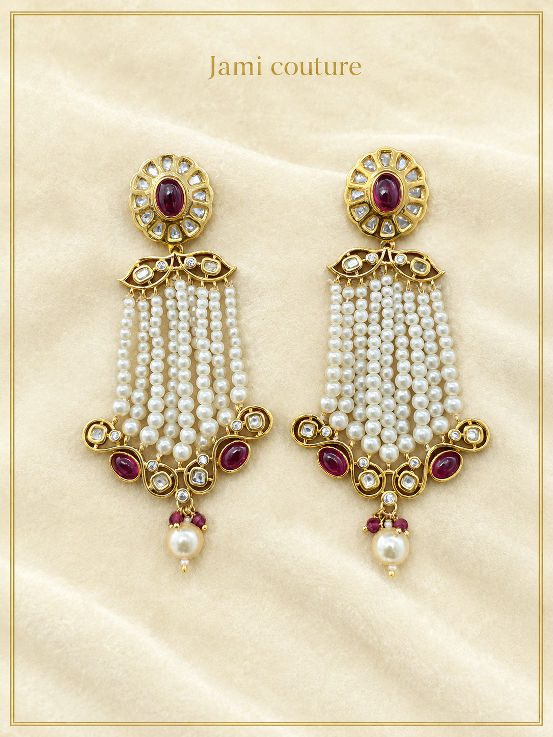 Pair of kundan chandelier earrings with ruby tops and pearl cascade fringe, laid flat