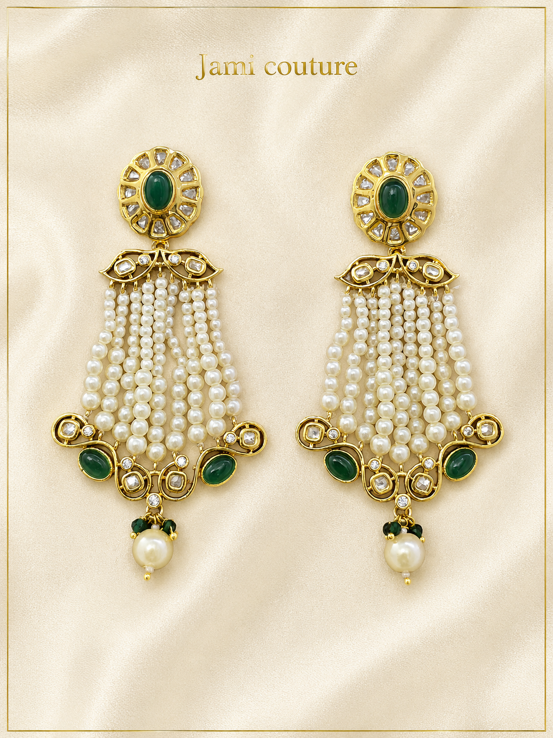 Pair of kundan chandelier earrings with emerald tops and pearl cascade fringe, laid flat