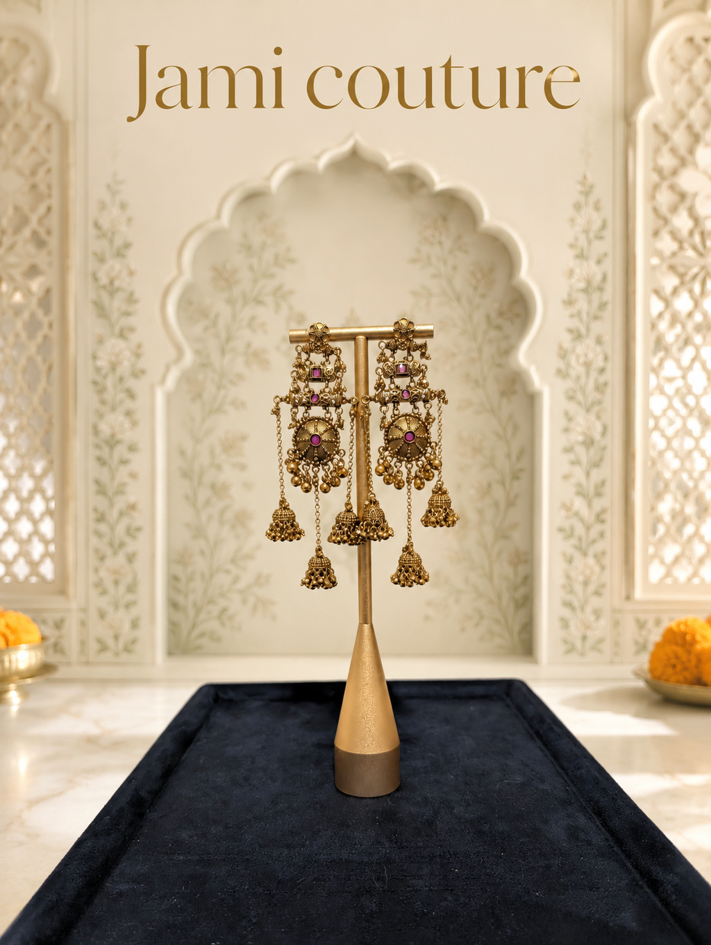 Antique gold chandelier jhumka earrings on a stand in an arched temple-style setting