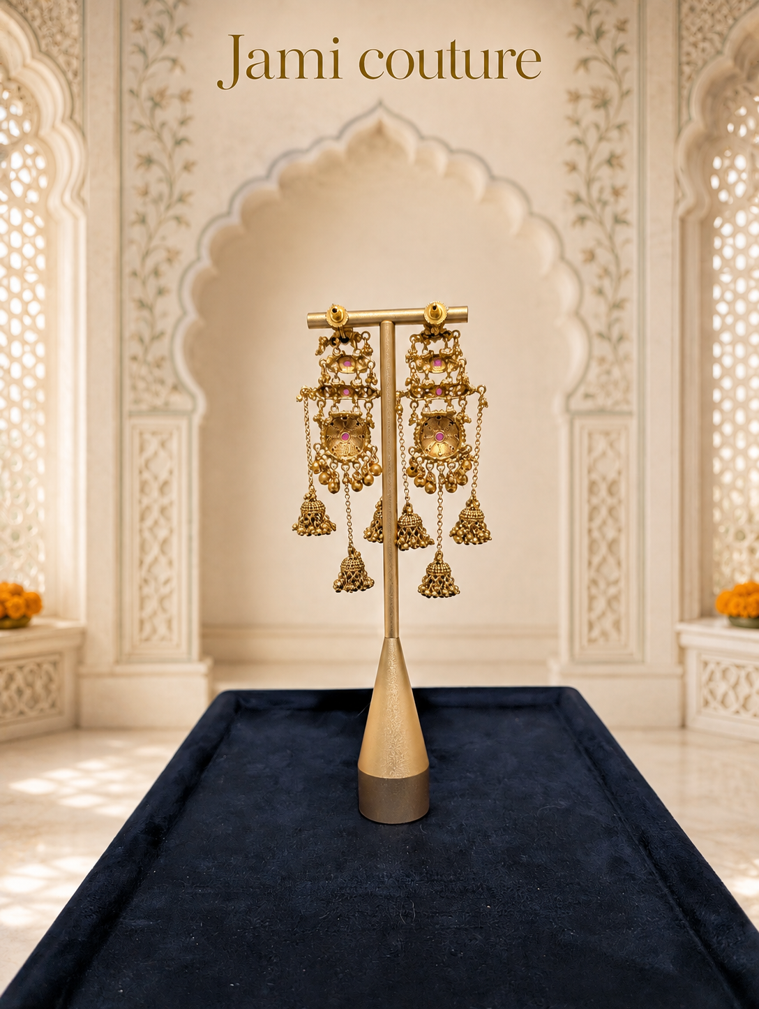 Close view of the antique gold chandelier jhumka earrings with their layered bell drops on a stand