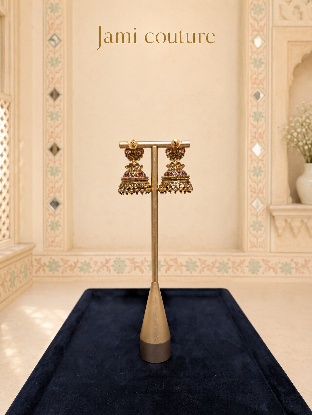 Close view of the temple jhumka earrings on a stand over navy velvet