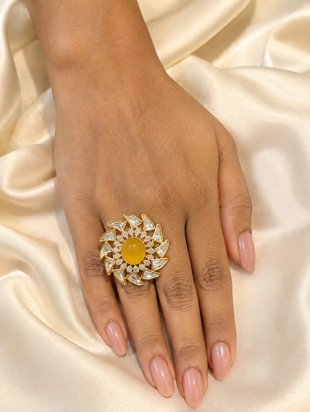 Model wearing the yellow opal and white kundan floral pinwheel ring