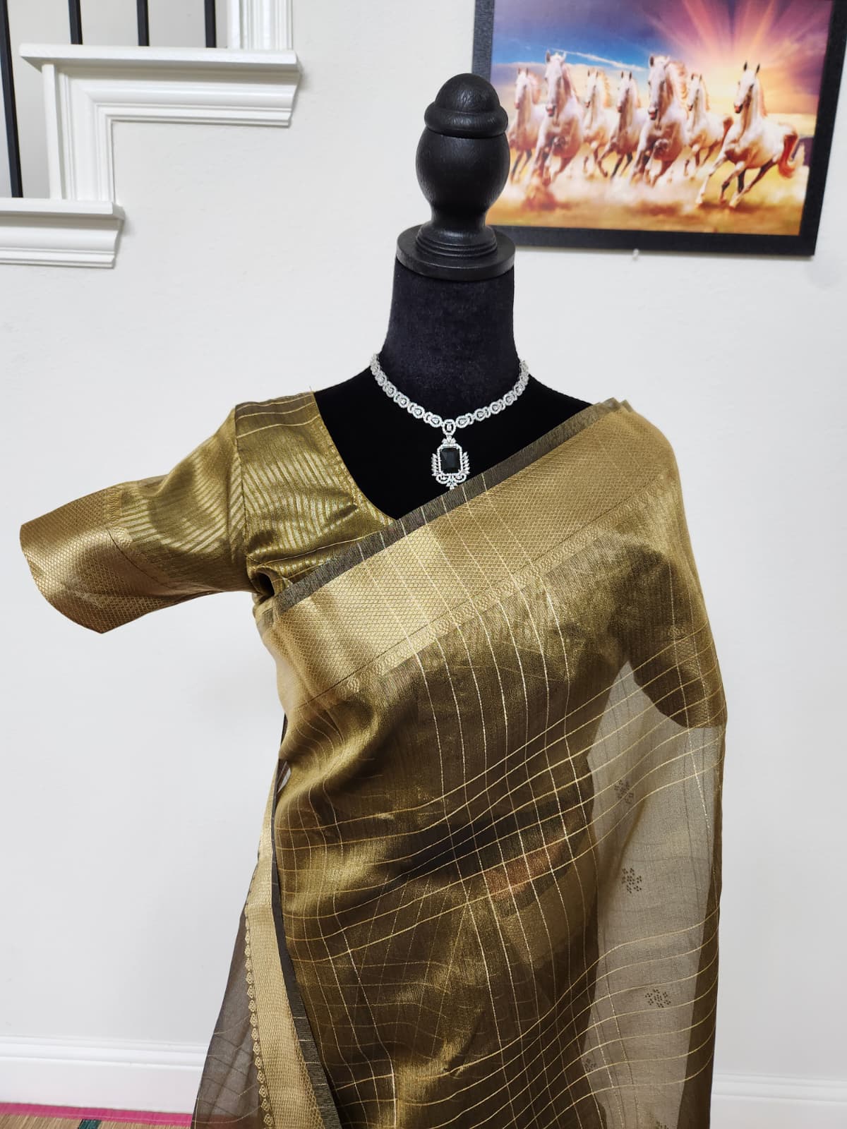 Natural-light close-up of the antique gold tissue organza saree front and matching blouse