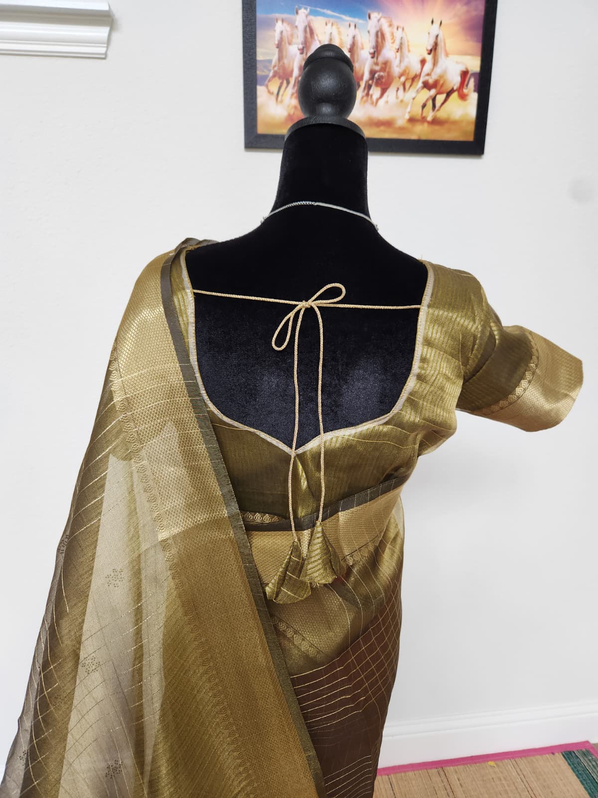 Natural-light close view of the antique gold blouse back and organza pallu