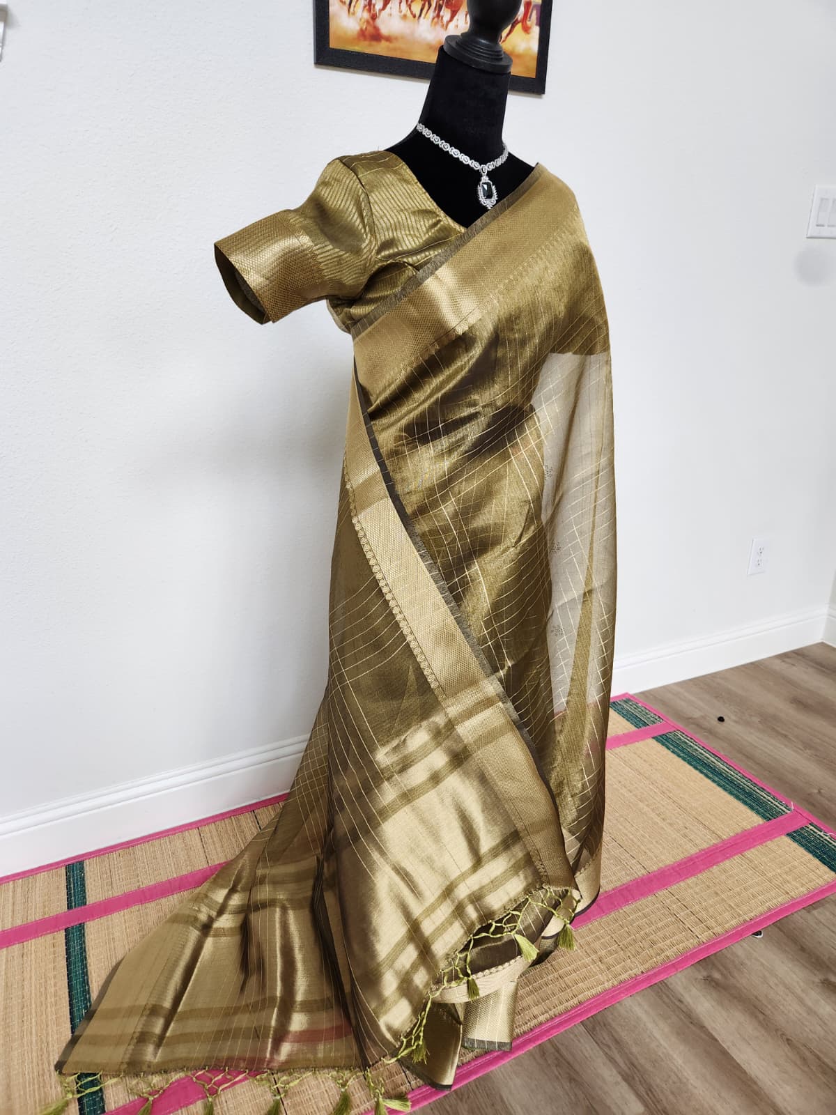 Natural-light three-quarter view of the deep antique gold tissue organza saree