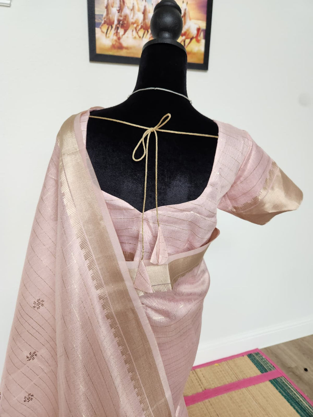 Natural-light close-up of the blouse back with gold tie-back tassels, zari sleeve border and the zari-butti pallu