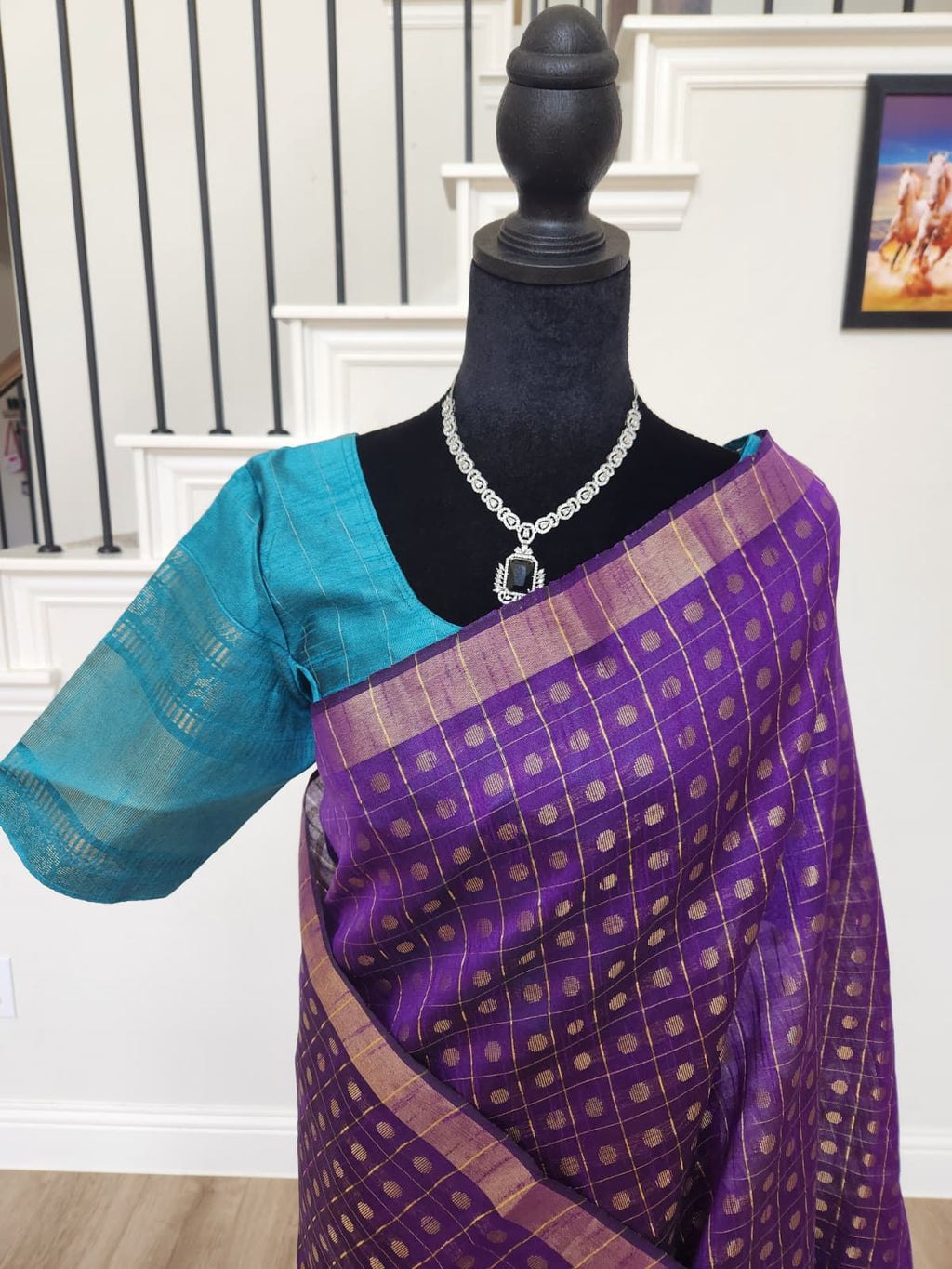 Natural-light close-up of the gold butta checks on the purple body and the teal blouse