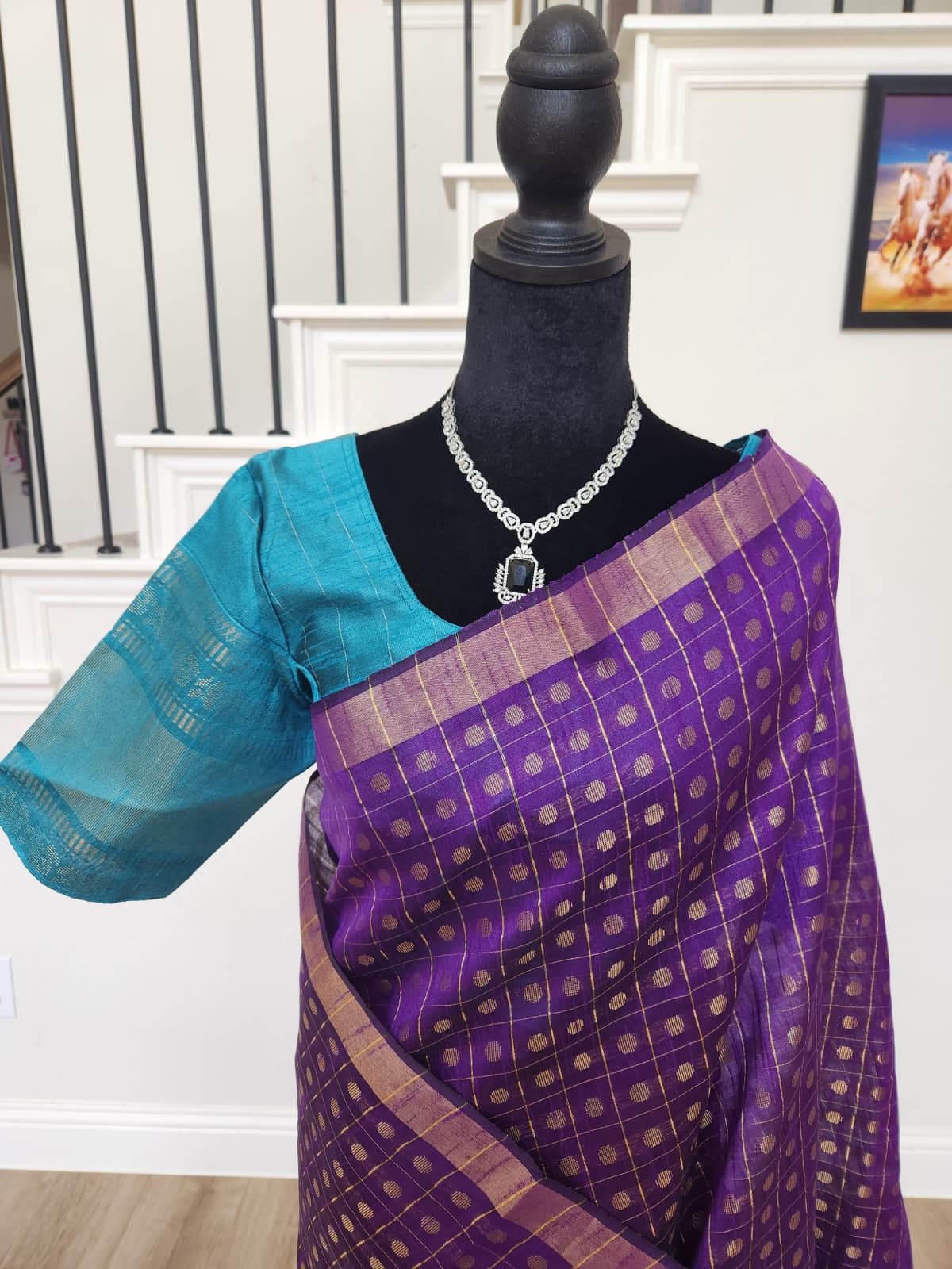 Natural-light close-up of the gold butta checks on the purple body and the teal blouse