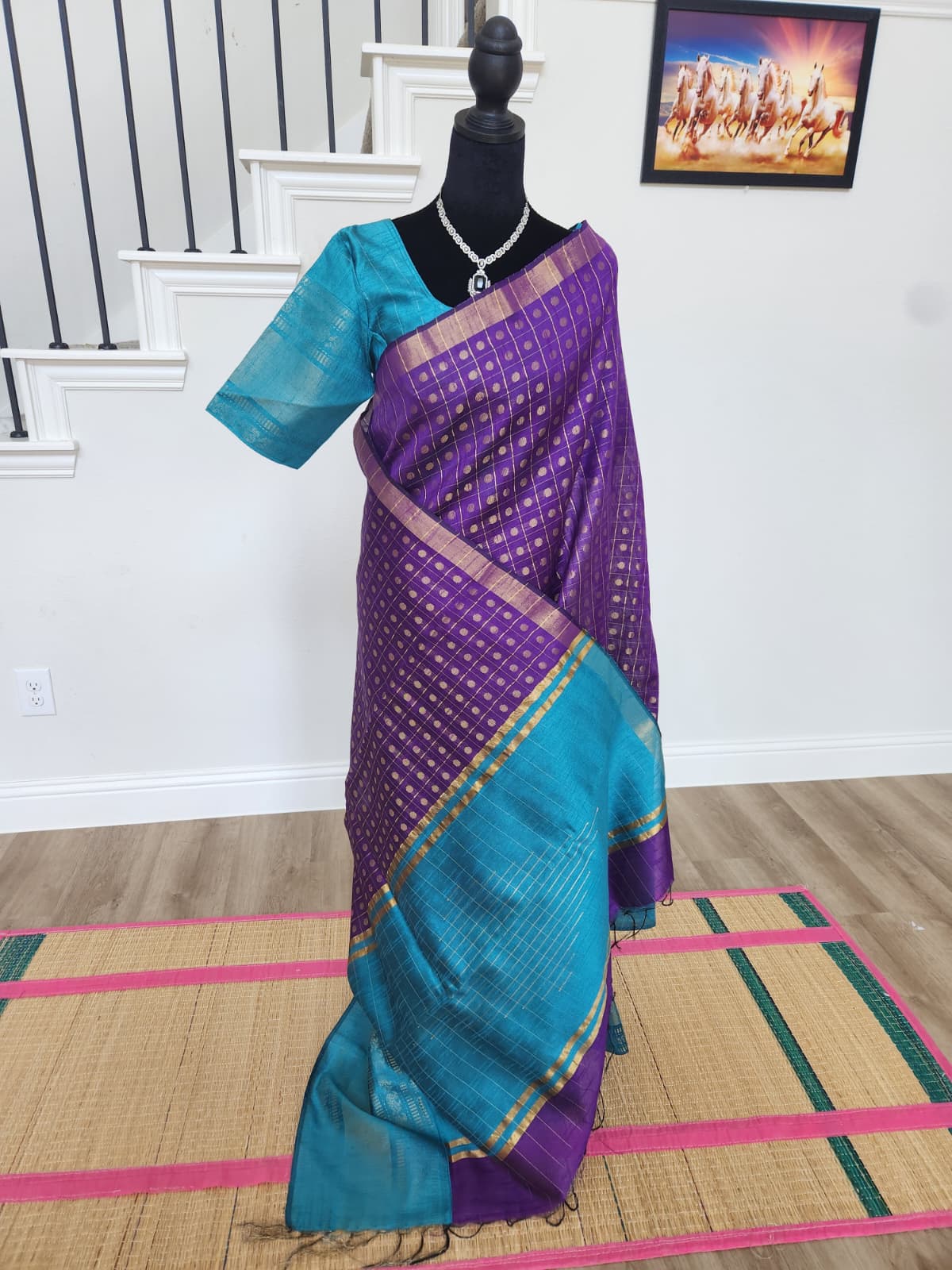 Natural-light full-length view of the purple saree with the teal pallu draped in front