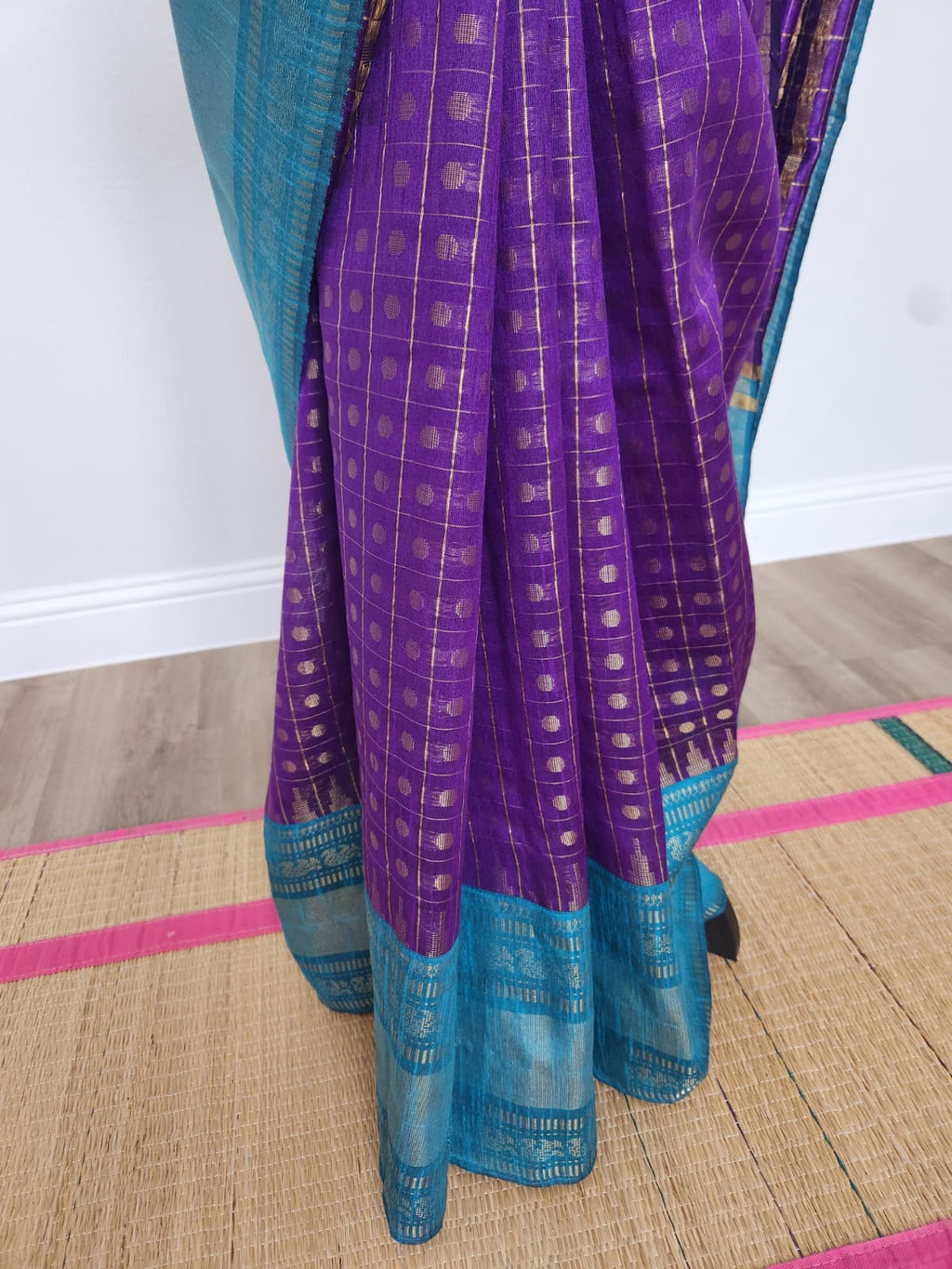 Natural-light close-up of the saree pleats showing the purple butta body and teal zari border