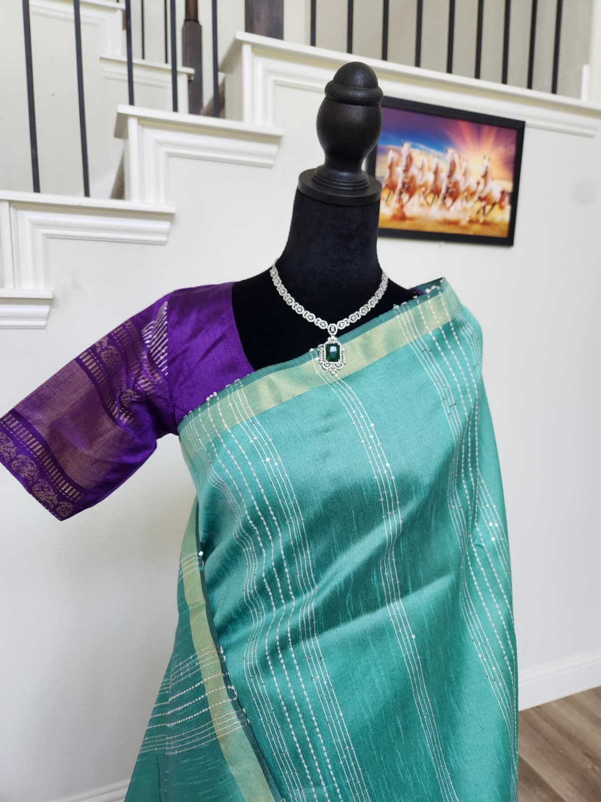 Natural-light close-up of the turquoise silk with silver stripes and matching purple blouse