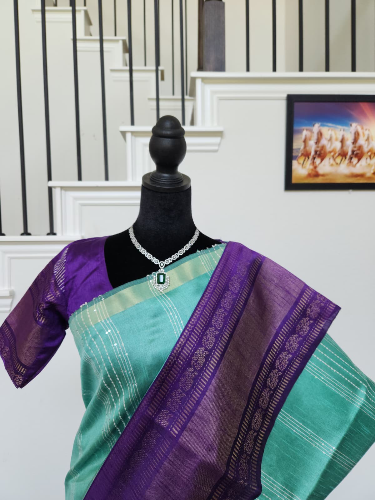 Natural-light close-up of the royal purple zari pallu over the shoulder