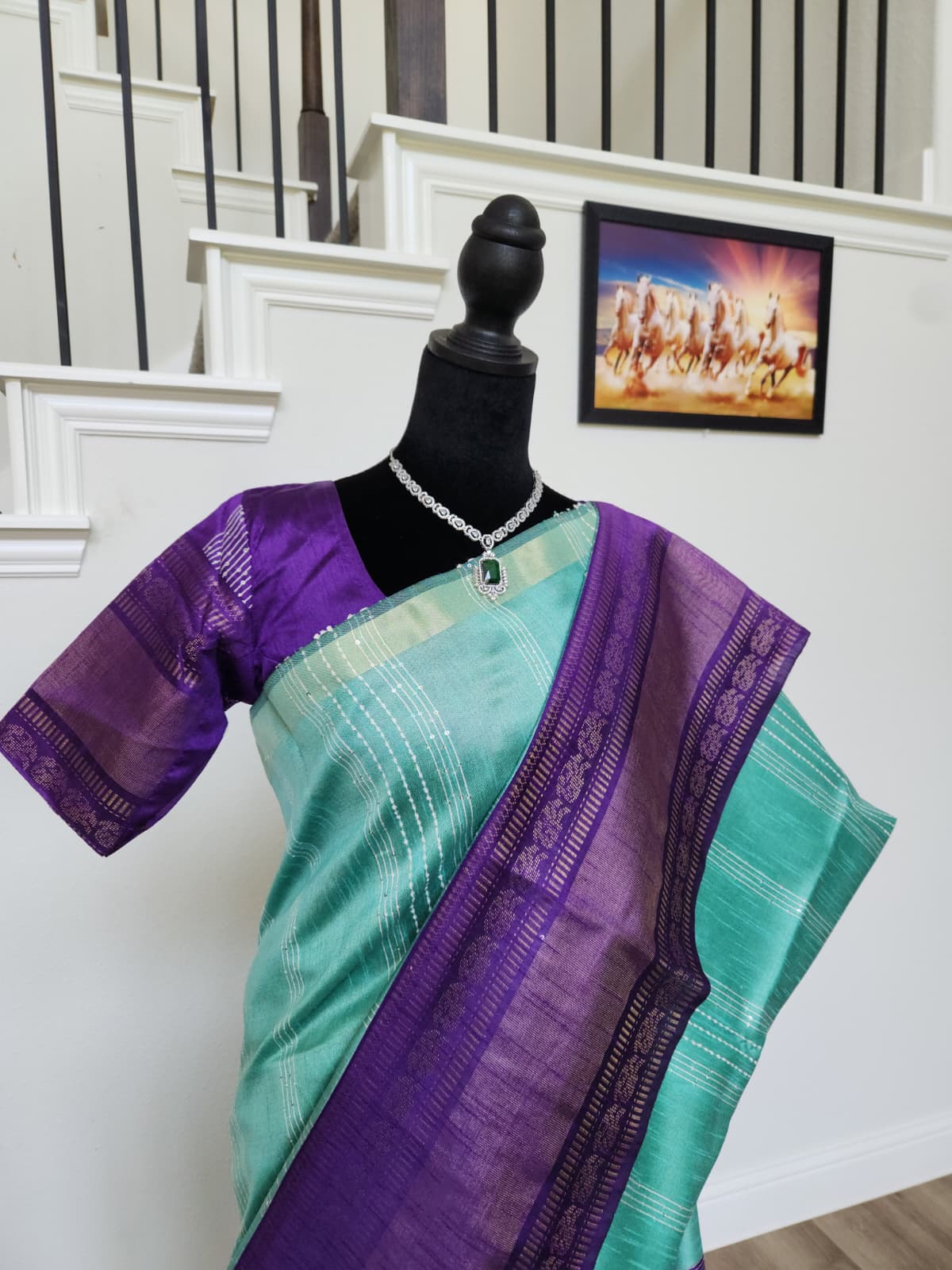 Natural-light view of the purple zari pallu draped over the turquoise saree