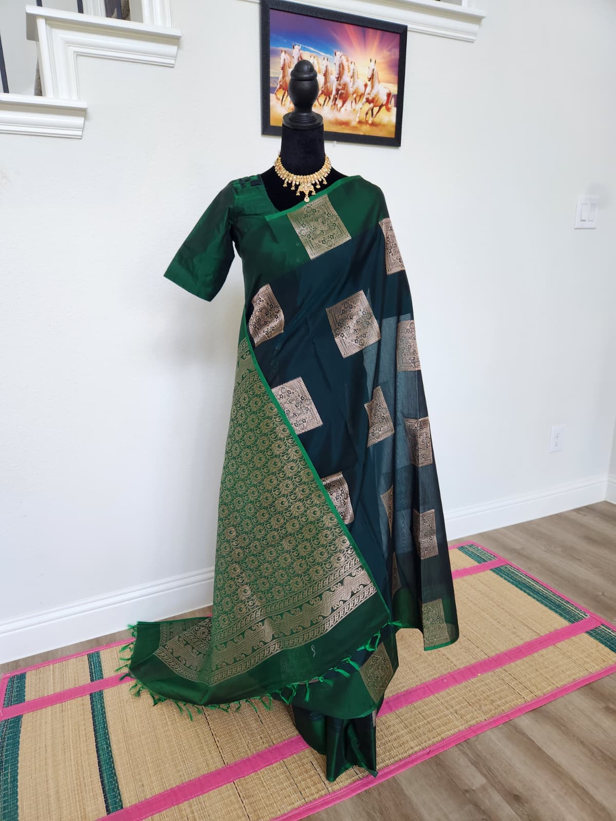 Natural-light photo of the bottle green Kanchi cotton saree, front view, with gold brocade buttis and pallu