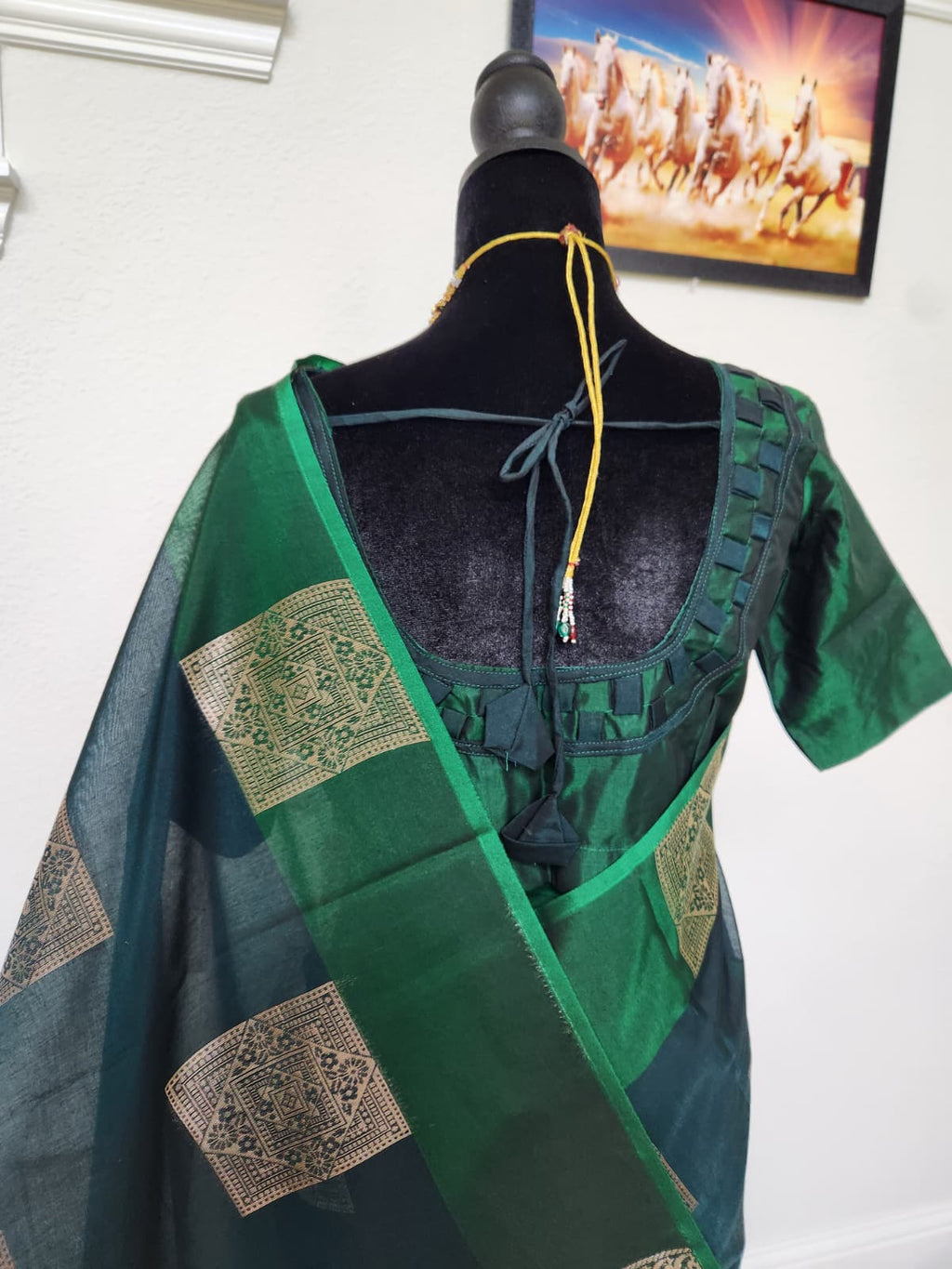 Natural-light close-up of the blouse back with tie closure and the brocade-butti pallu