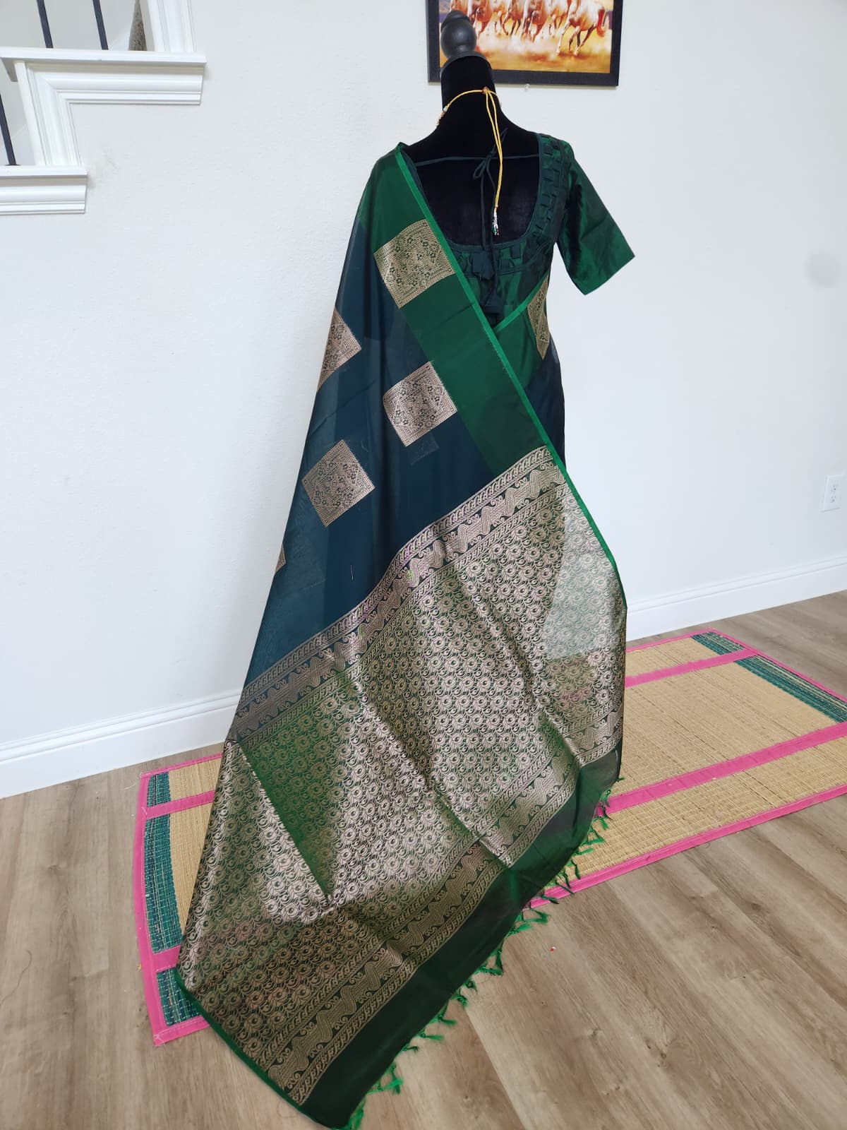 Natural-light back view of the bottle green Kanchi cotton saree with the gold zari brocade pallu