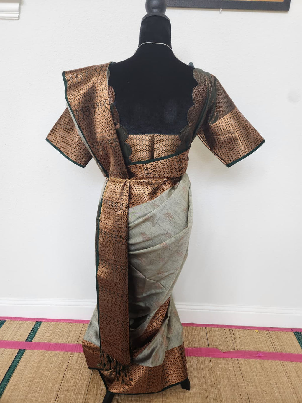 Natural-light back view of the saree and matching blouse with scalloped back