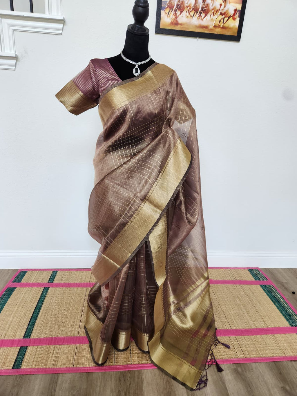 Natural-light front view of the wine tissue organza saree with gold zari border and pleats