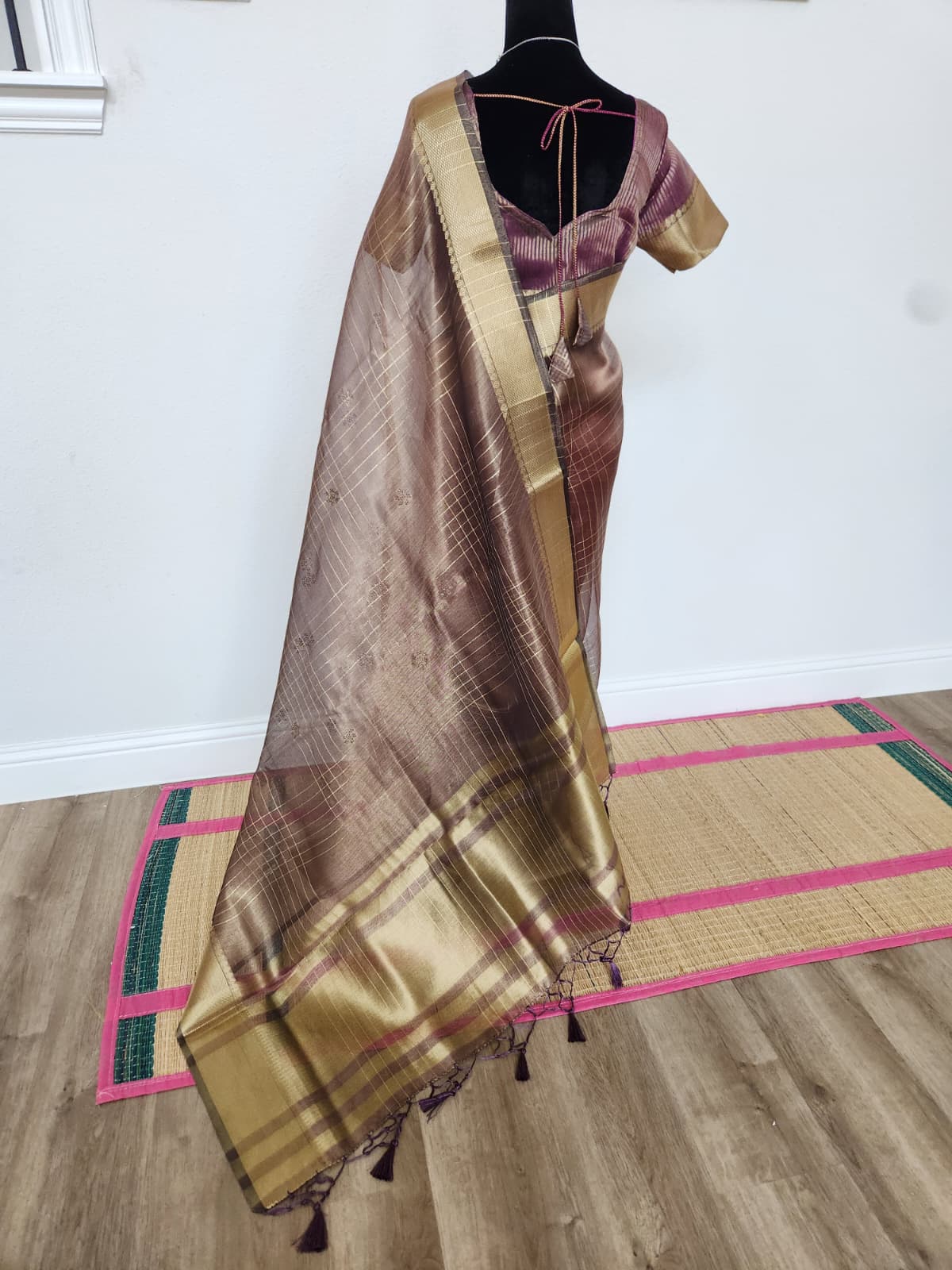 Natural-light back view of the wine tissue organza saree with the sheer pallu and tassels